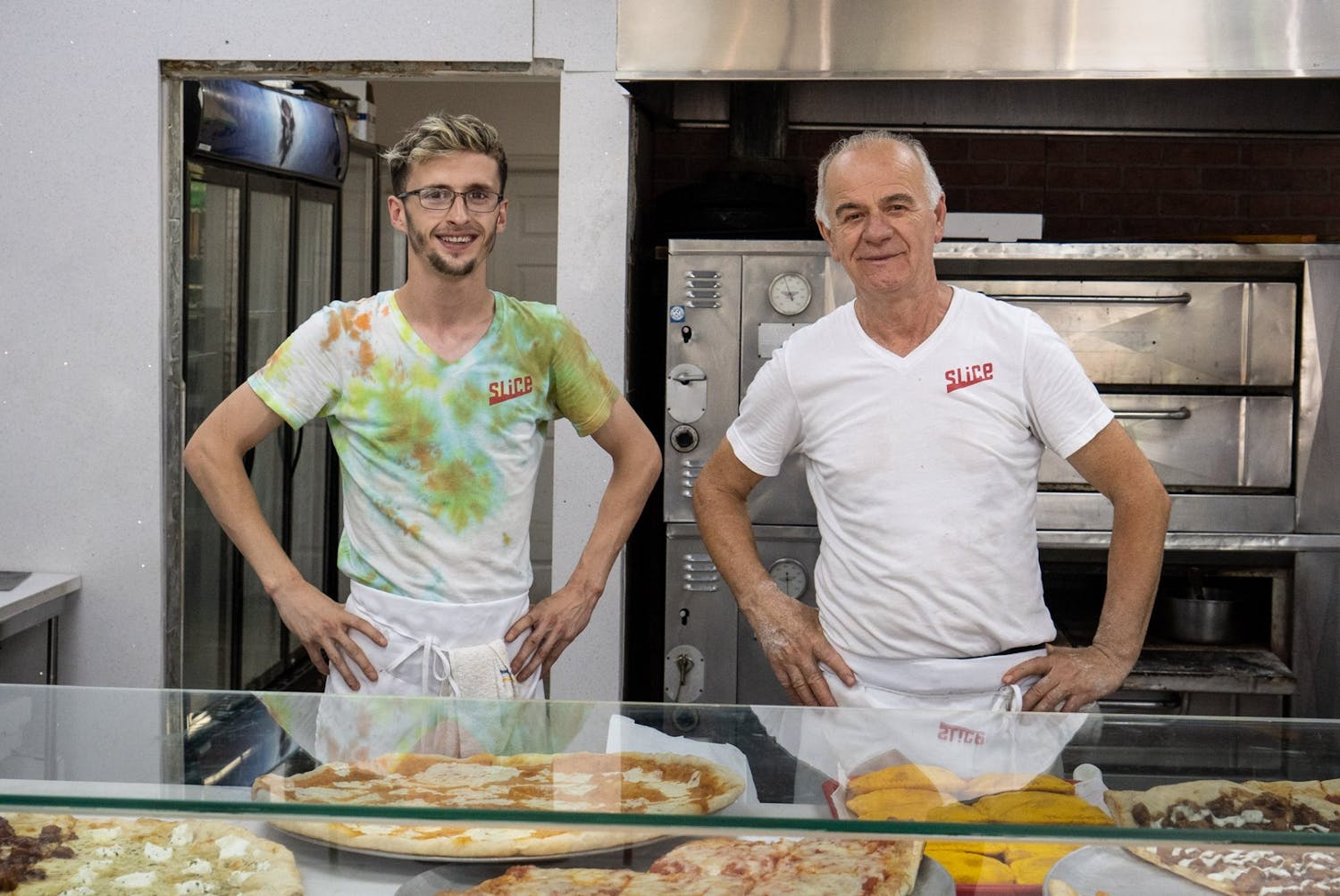 Pizza Mia staff standing in front of the pizza oven in Staten Island