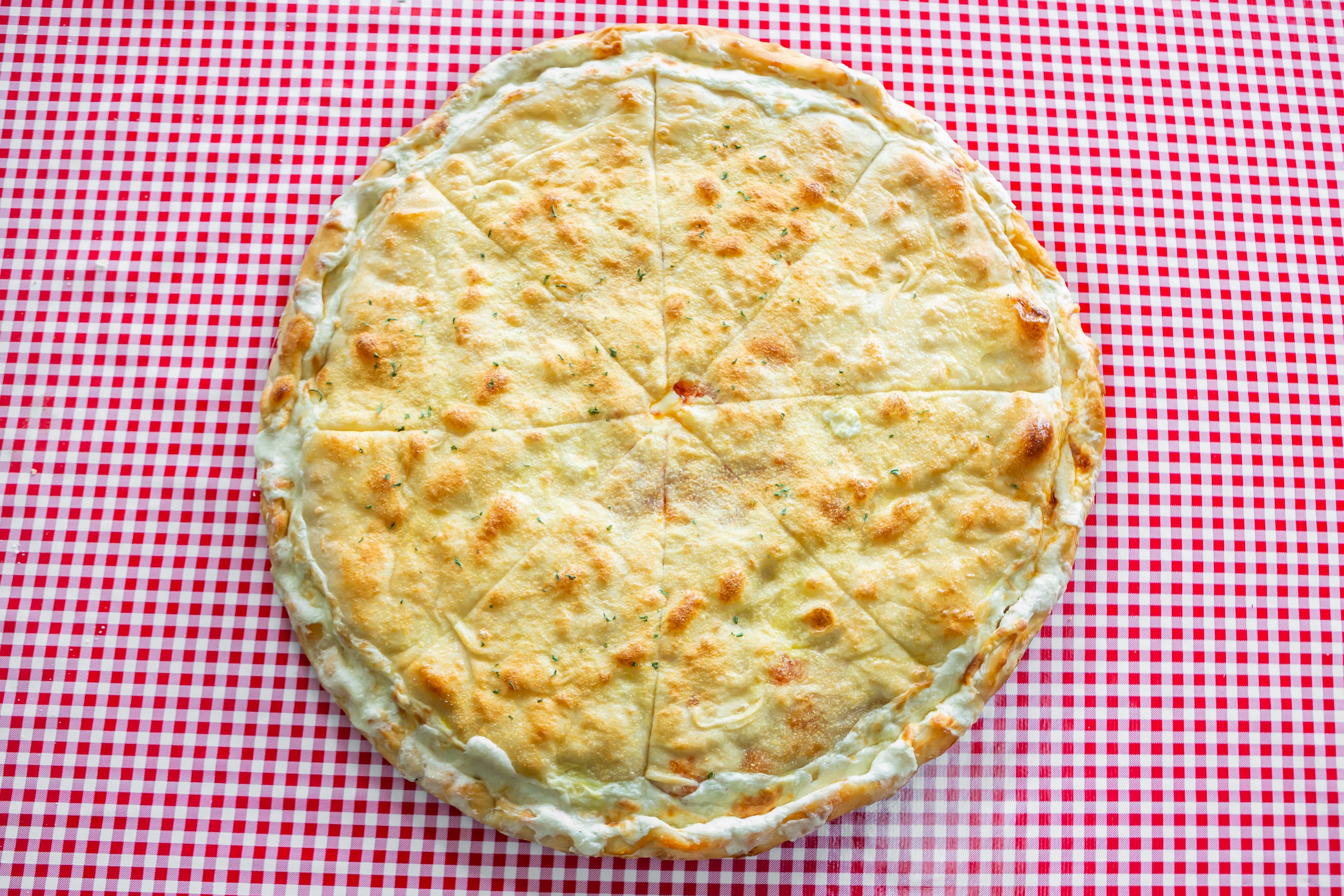 https://slicelife.imgix.net/15121/photos/original/NizzaPizza_StuffedSpinachPie.jpg?auto=compress&auto=format